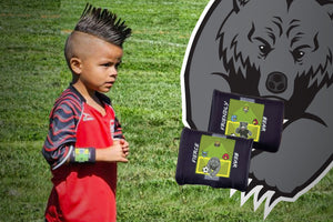 Soccer kid with spiked hair wearing a Stumbling GOAT wrist coach